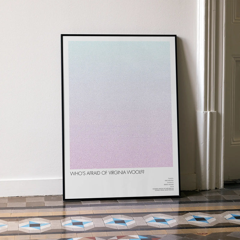 A framed Who's Afraid of Virginia Woolf? movie script poster leaning against a wall in a minimalist interior.