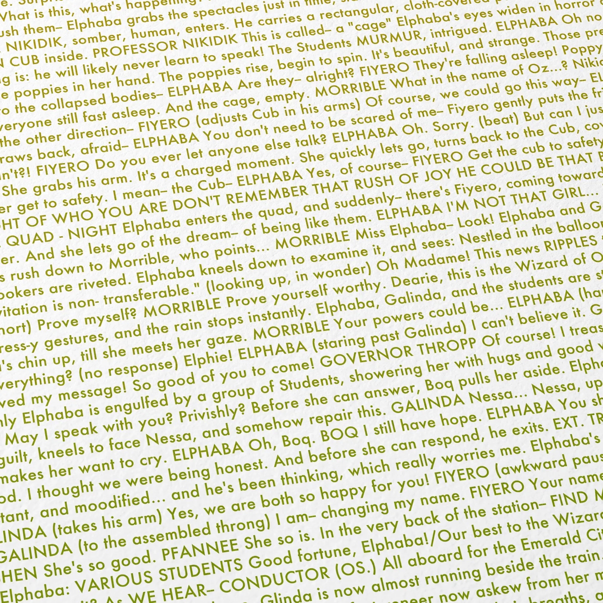 Close-up detail of the Wicked movie script poster showing dense typographic text.