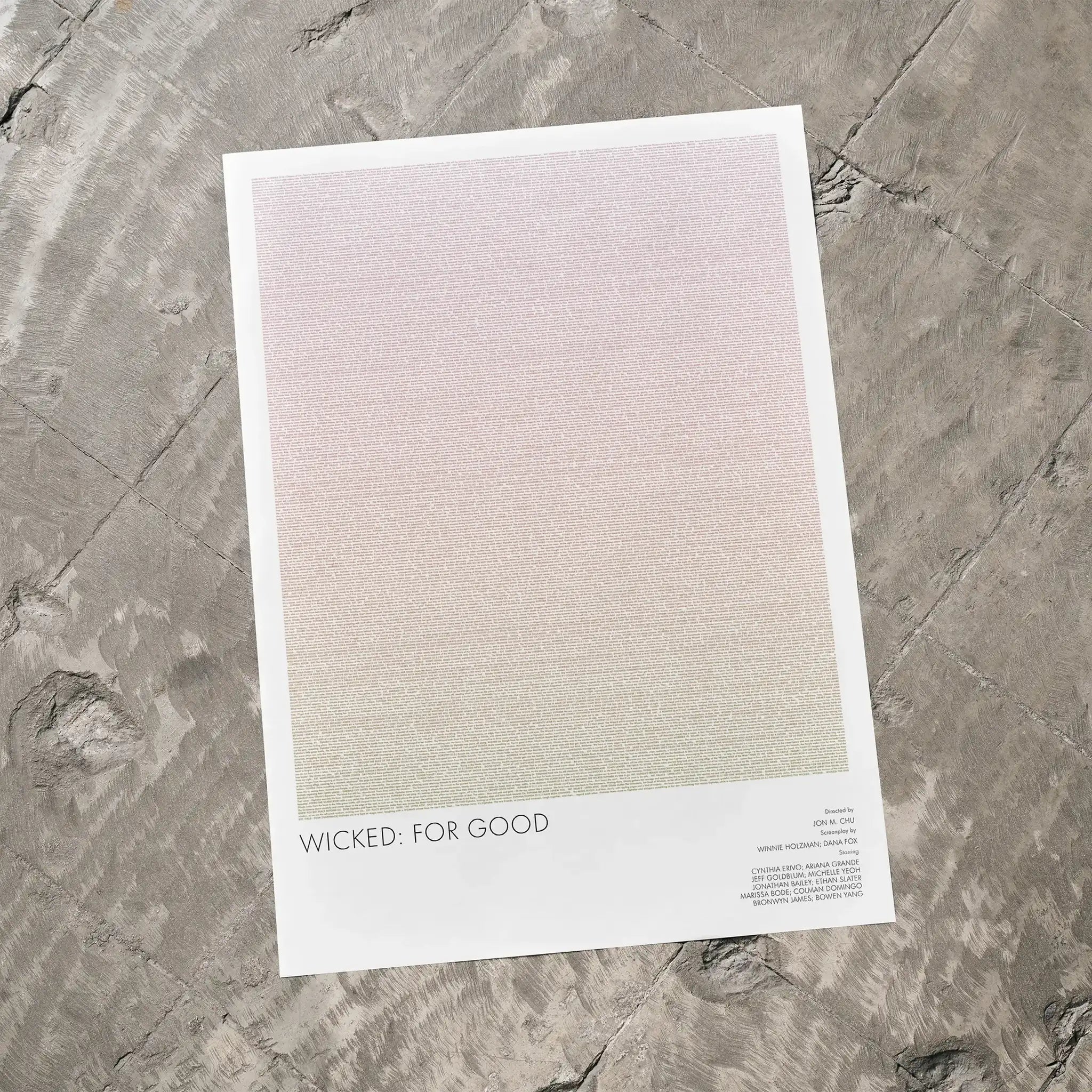A Wicked for Good movie script poster laid flat on a textured floor surface.