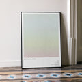 A framed Withnail & I movie script poster leaning against a wall in a minimalist interior.