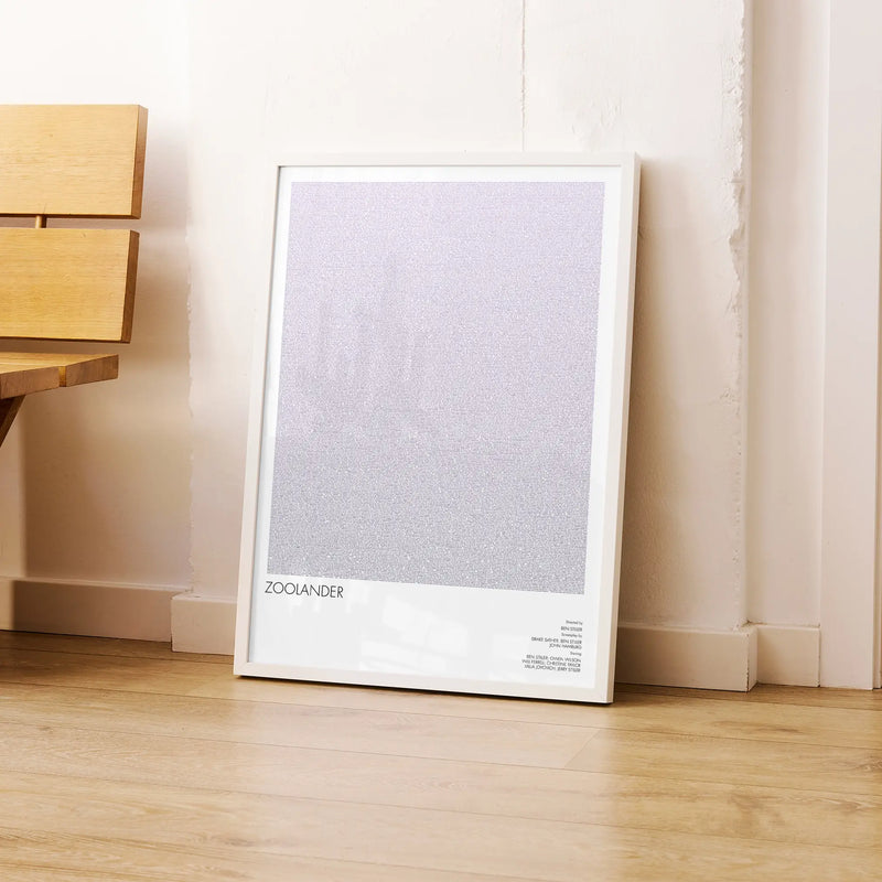 A framed Zoolander movie script poster leaning against a wall in a modern interior.