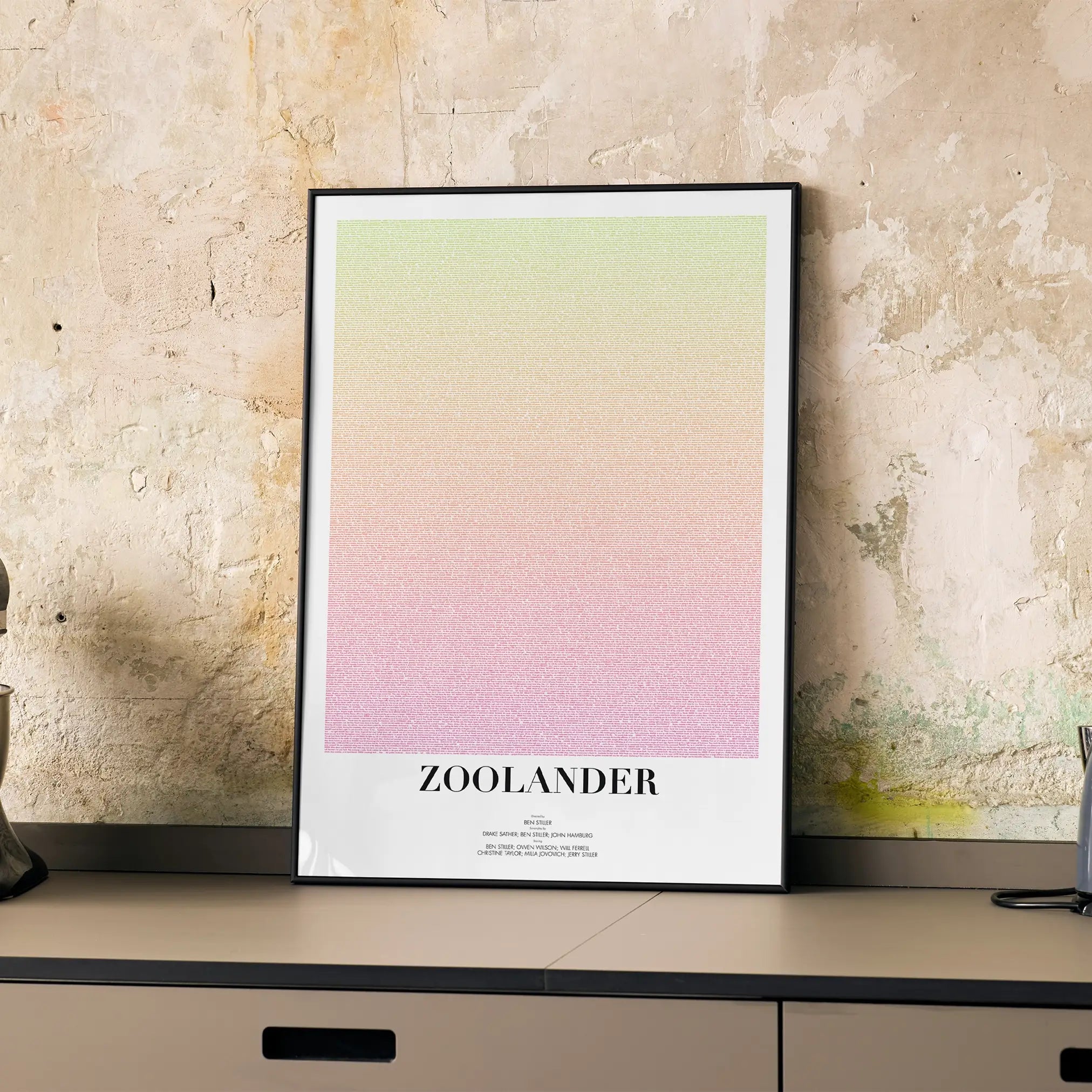 A framed Zoolander movie script poster displayed on a cabinet in a minimalist interior.